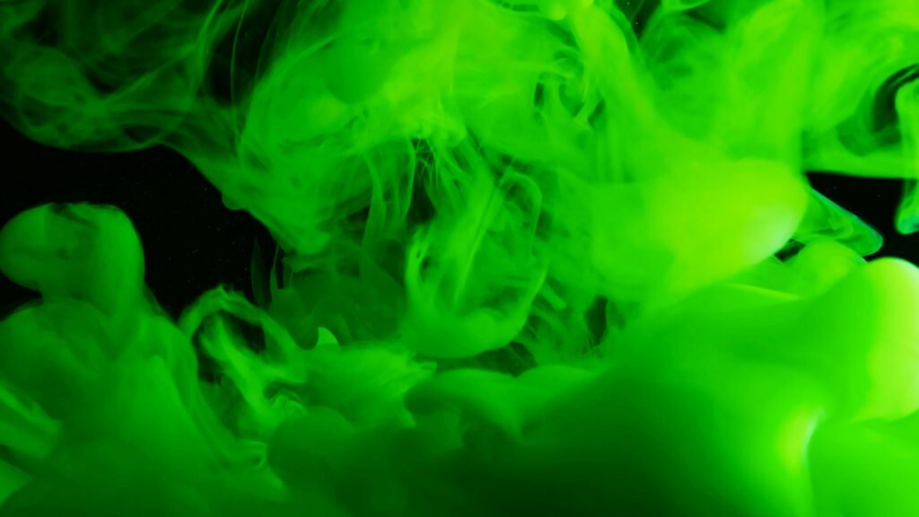 Home Vivid green ink swirling in liquid creates a mesmerizing abstract texture.